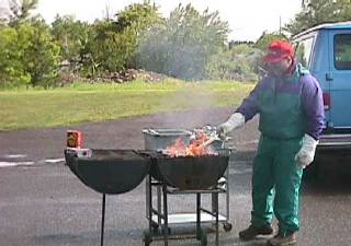 John fights the elements and the grill