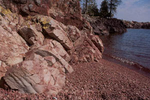 This pink rhyolite beach at Fish Cove, with its variety of geology and plant life, is one of the Keweenaw Tip sites photographer Charlie Eshbach showed Natural Resources Trust Fund Board members during their September 12, 2001, meeting in Lansing. (Photo courtesy Charlie Eshbach)