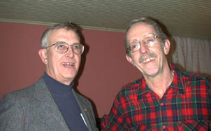 Bill Deephouse, left, president of the Copper Country Chapter of Trout Unlimited, chats with photographer Charlie Eshbach in the Calumet Theatre ballroom following the December 4, 2000, Public Access Keweenaw forum.